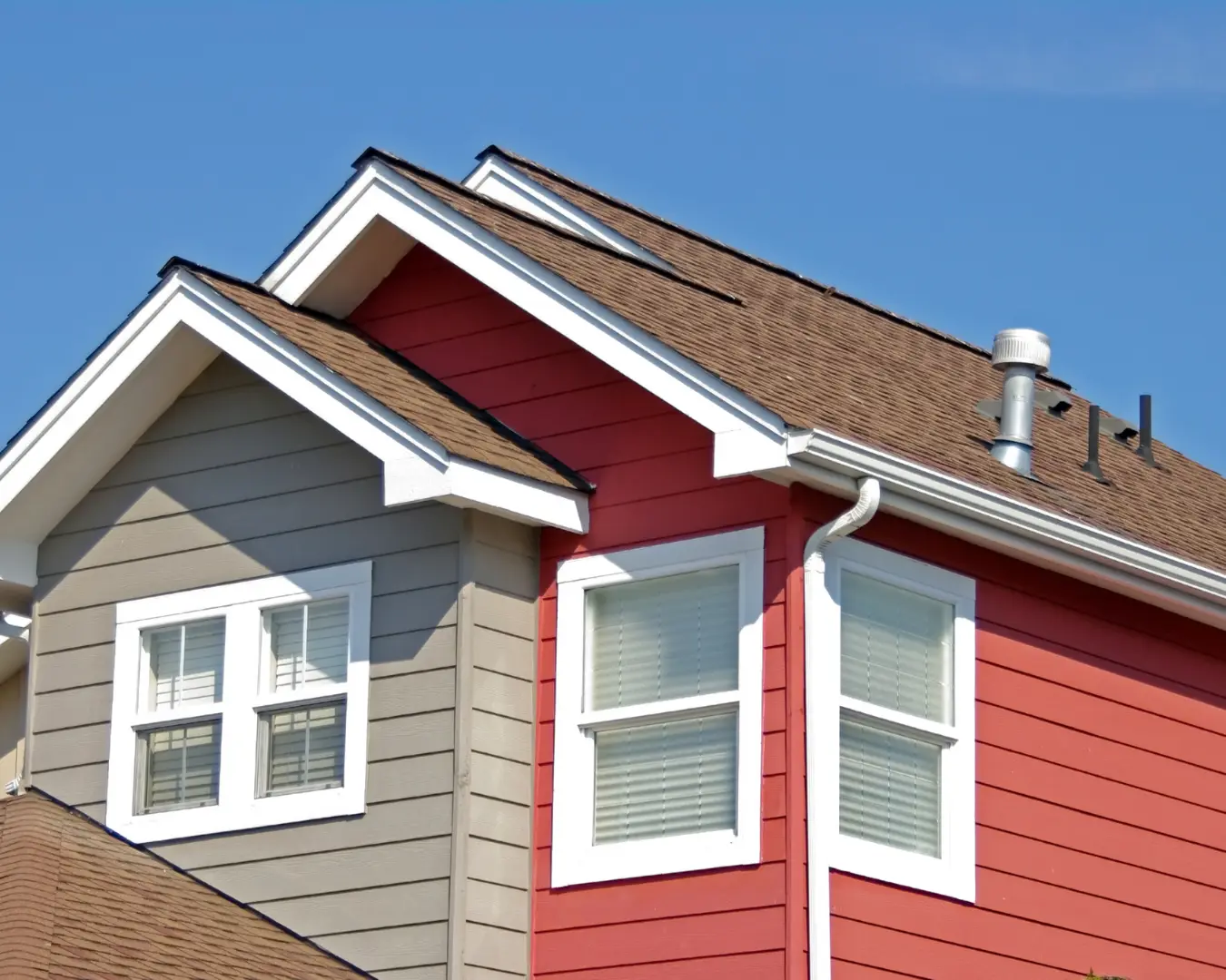 Completed roof replacement on a two-story home with fresh architectural shingles